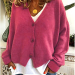 Gebreid vest met v-hals en knoopsluiting voor dames, los gedragen over een effen top